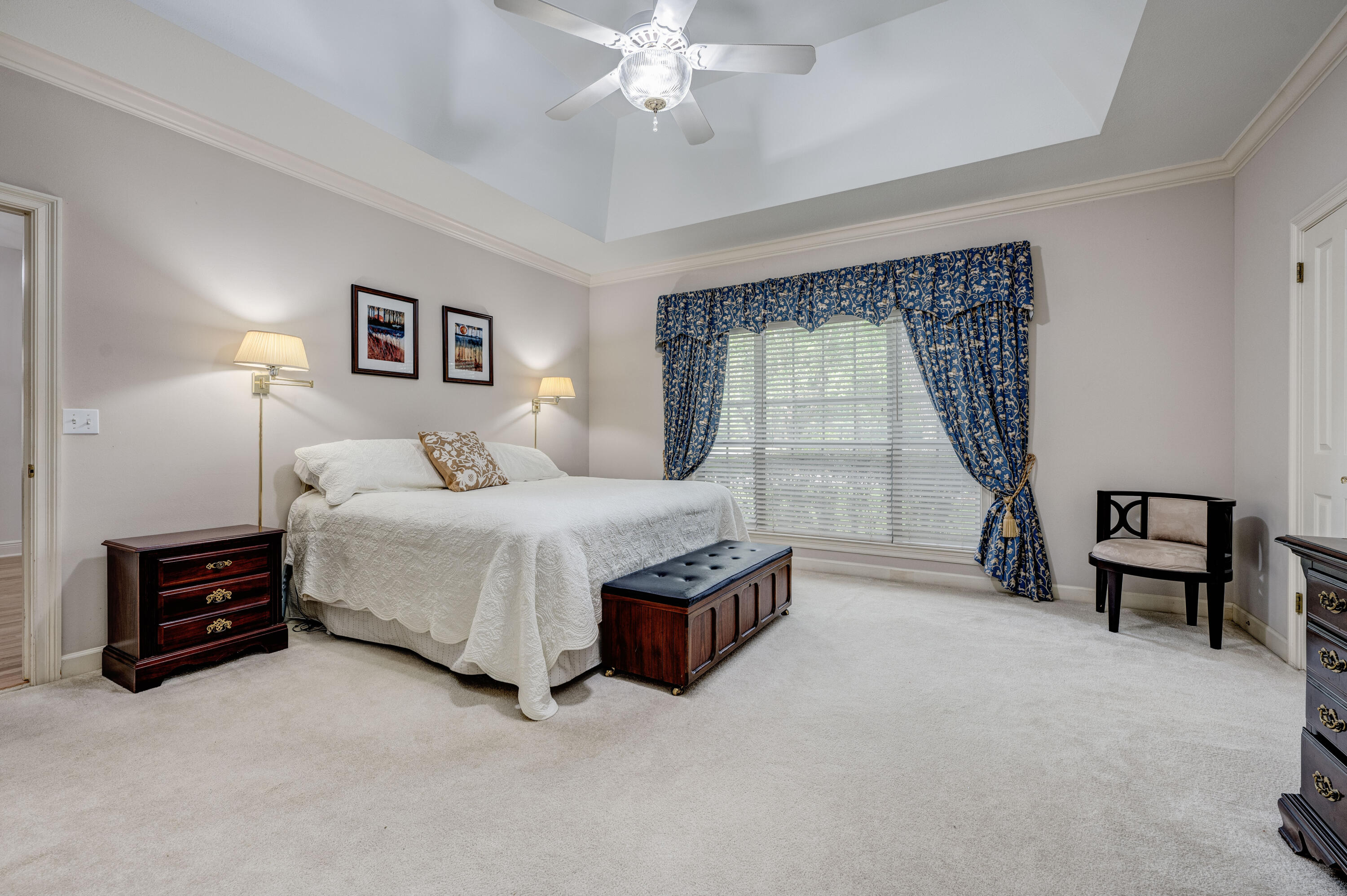 4418 Windrush Drive Niceville, FL 32578 - Photo 32 of 66 a bedroom with a bed and a chandelier