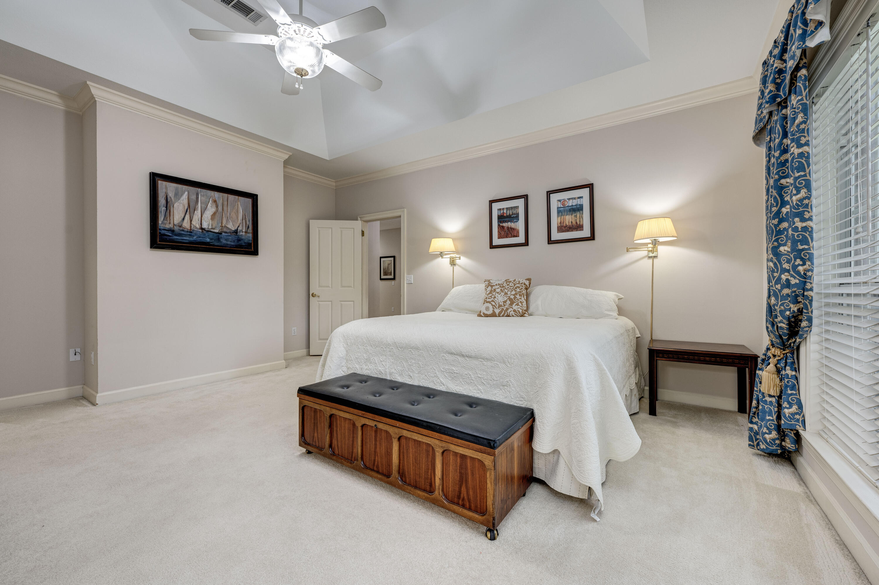 4418 Windrush Drive Niceville, FL 32578 - Photo 33 of 66 a spacious bedroom with a bed and a lamp