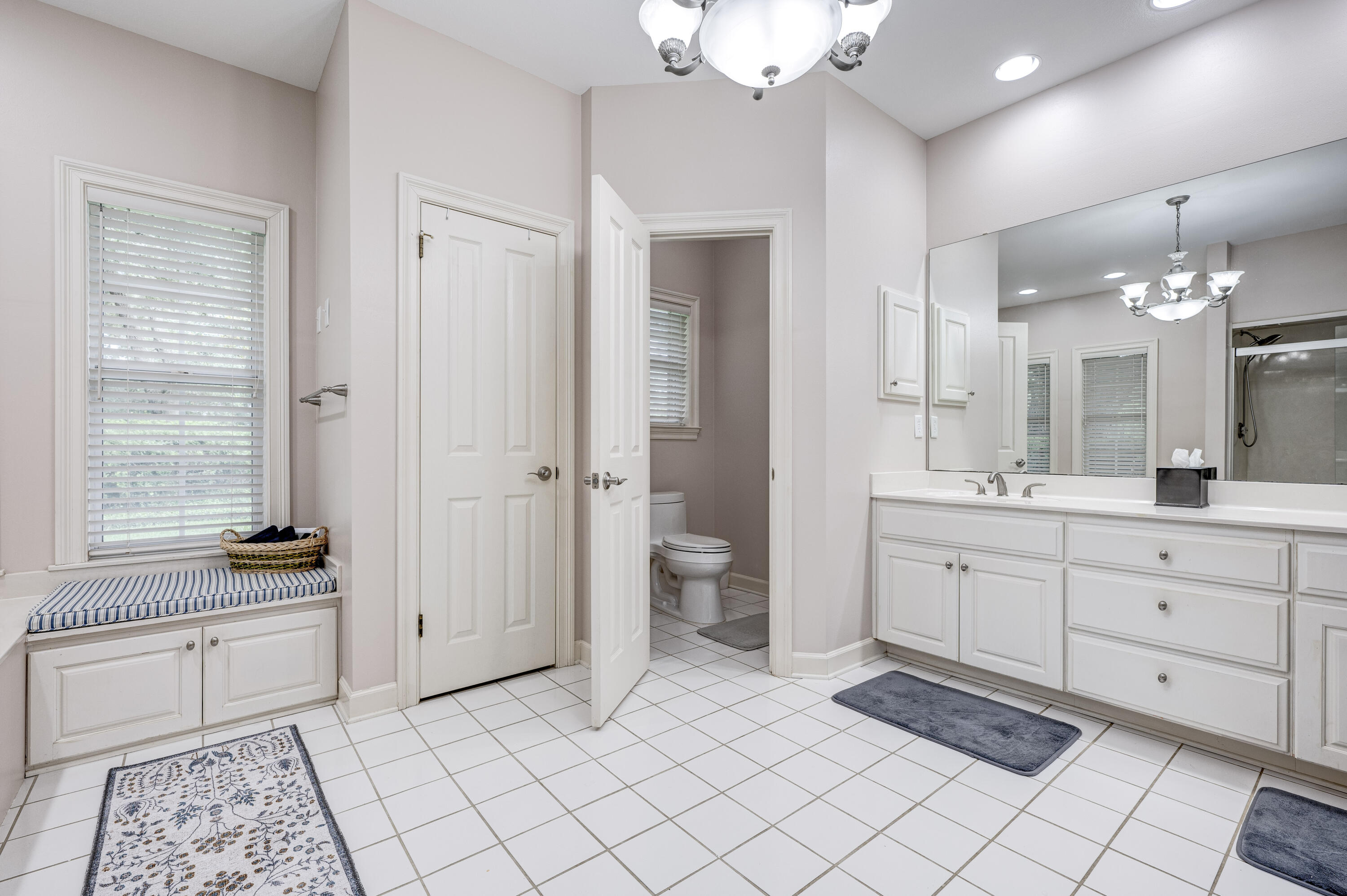 4418 Windrush Drive Niceville, FL 32578 - Photo 37 of 66 a spacious bathroom with a double vanity sink a mirror and a bathtub