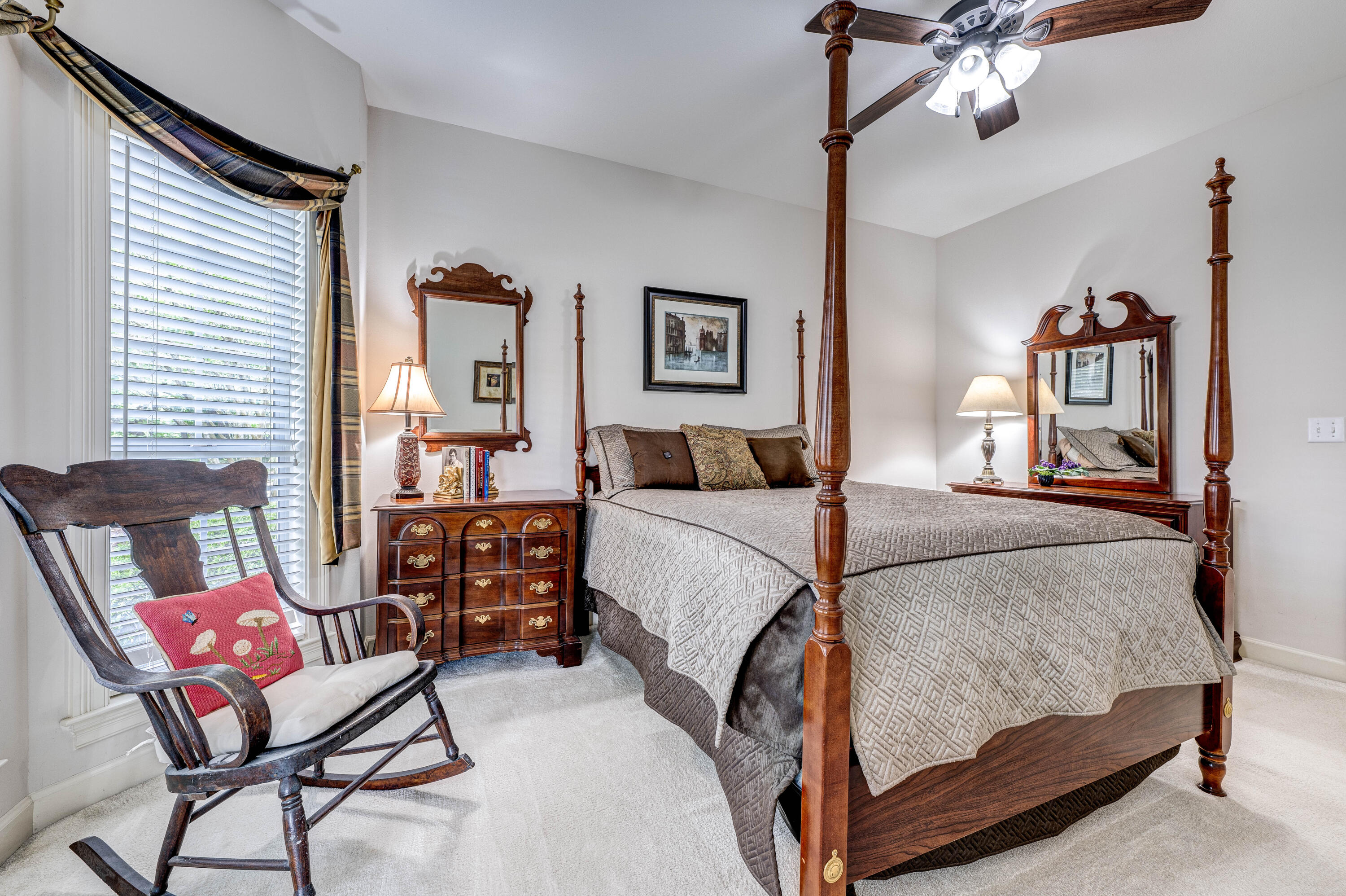 4418 Windrush Drive Niceville, FL 32578 - Photo 42 of 66 a bedroom with a large bed and a chandelier