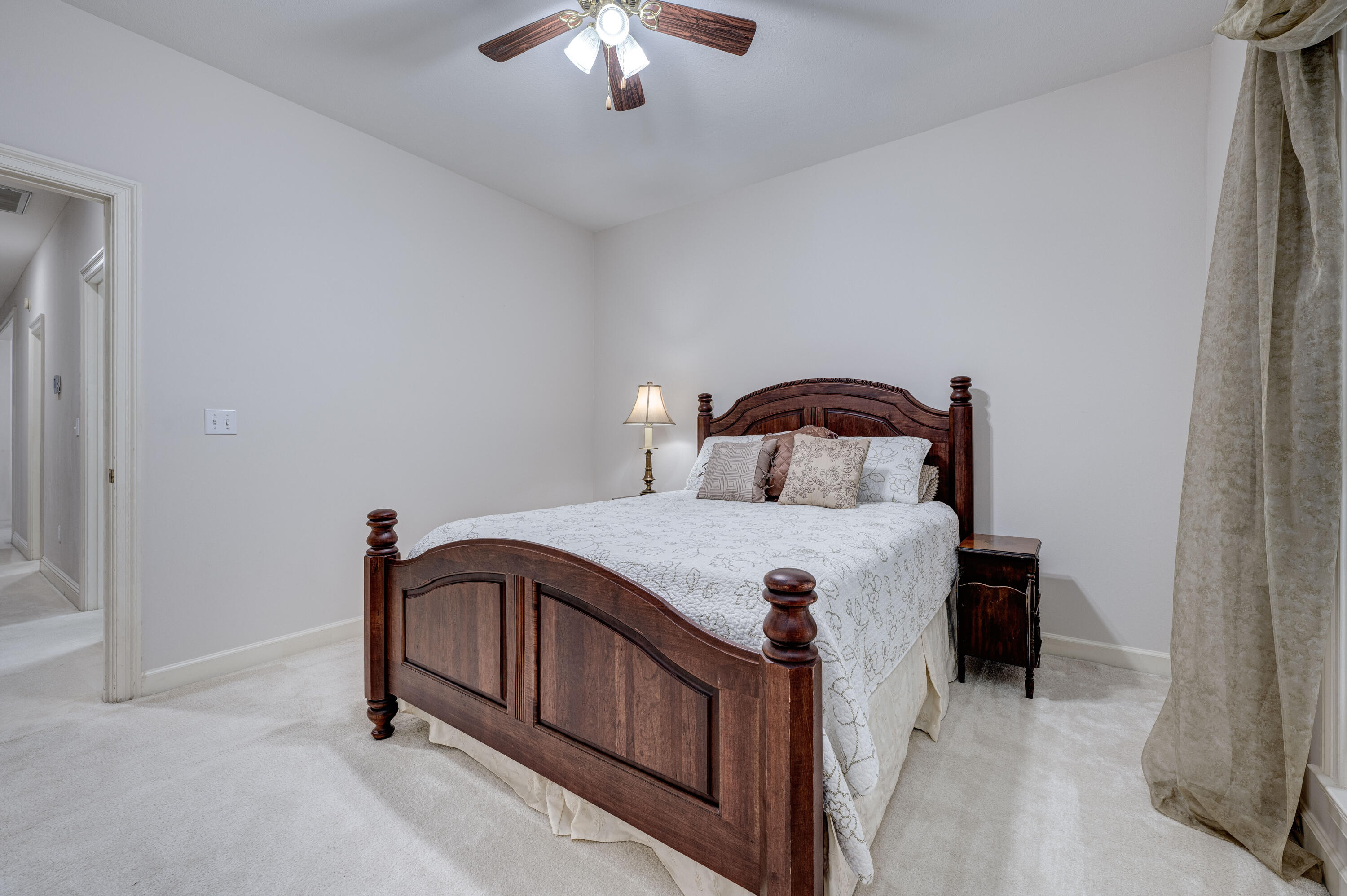 4418 Windrush Drive Niceville, FL 32578 - Photo 48 of 66 a bedroom with a bed and a chandelier