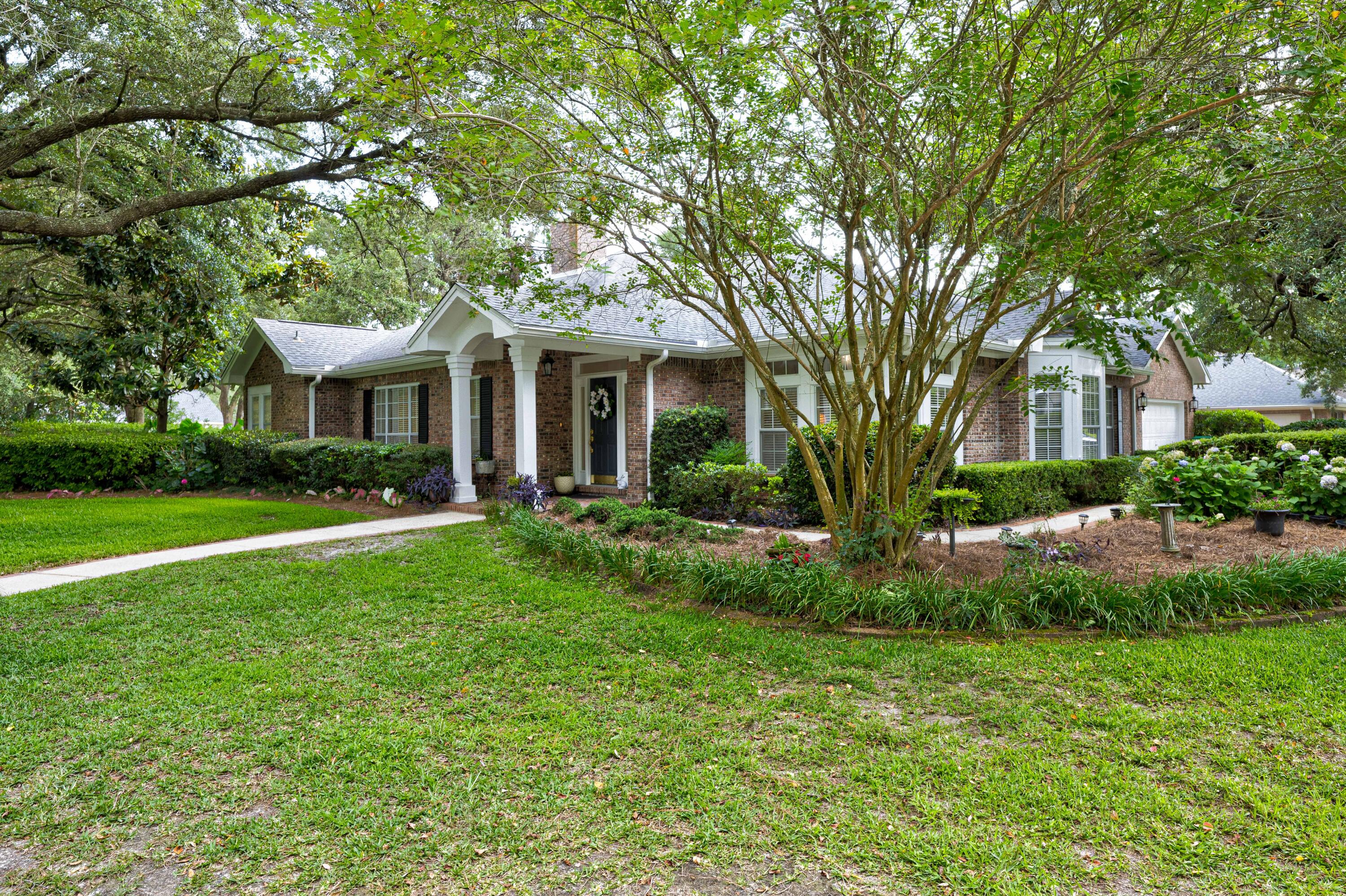 4418 Windrush Drive Niceville, FL 32578 - Photo 55 of 66 a front view of a house with yard and green space
