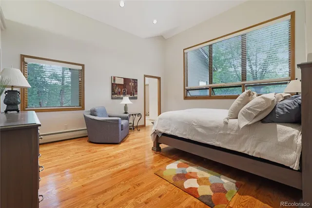 a bedroom with a bed and a large window