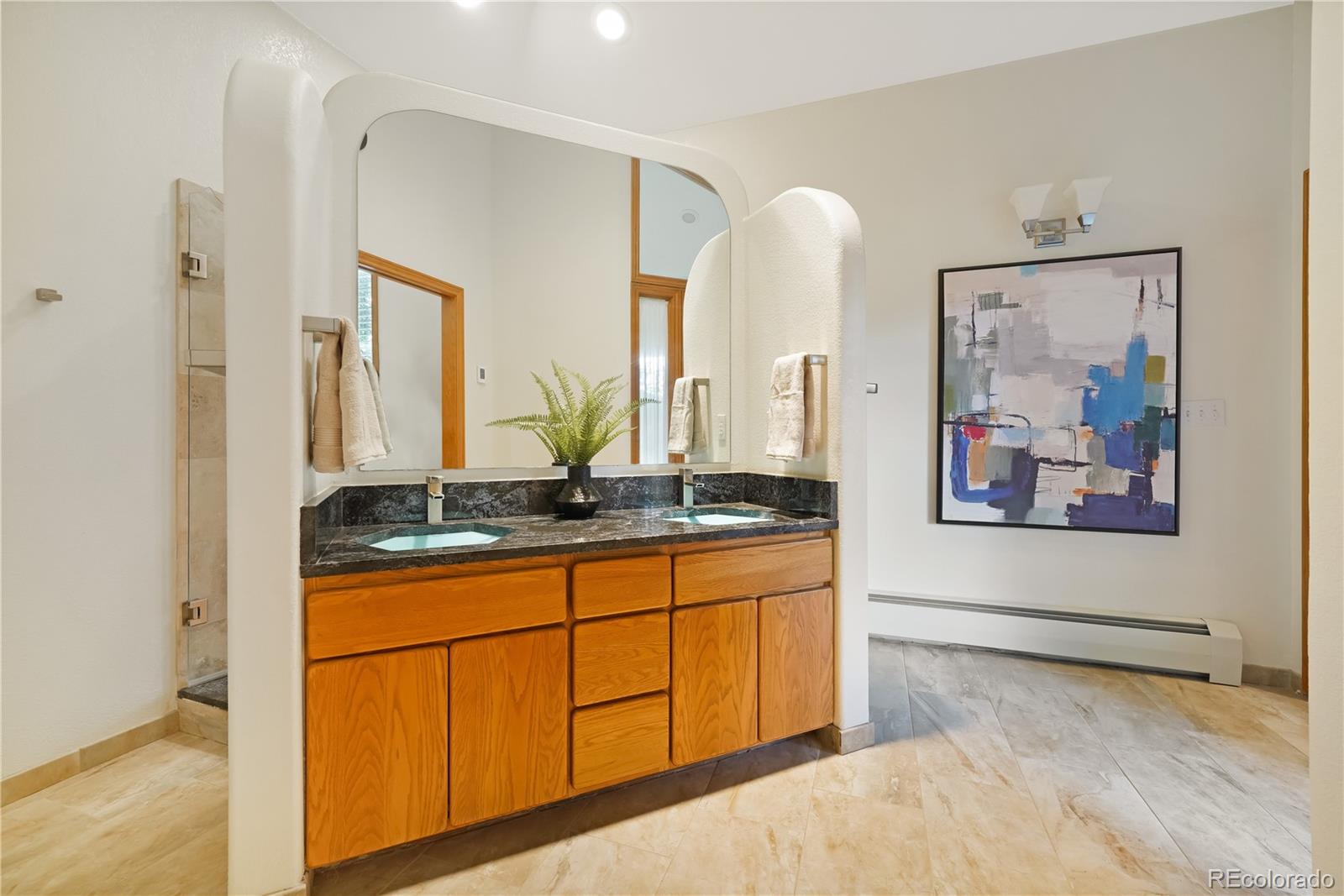 2398 Bitterroot Lane Golden, CO 80401 - Photo 16 of 34 a spacious bathroom with a double vanity sink and a mirror