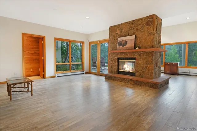 a view of a livingroom with furniture hardwood floor and a fireplace