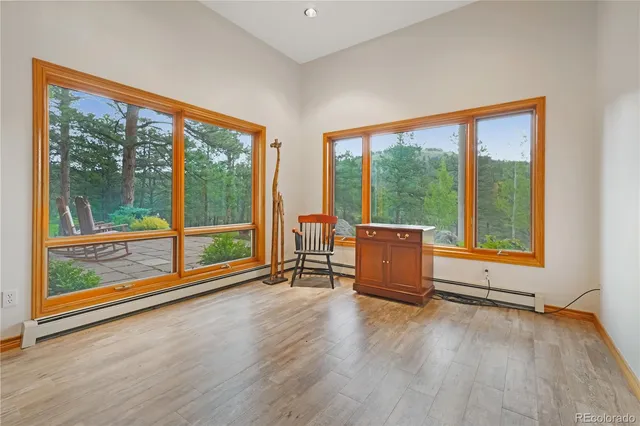 wooden floor in an empty room with a large window