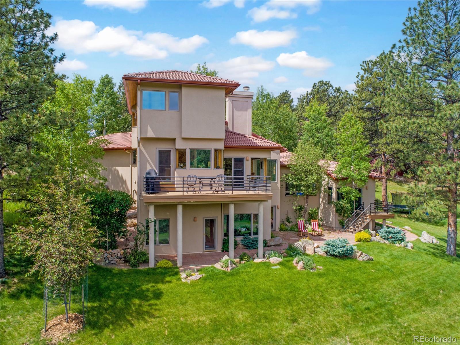 2398 Bitterroot Lane Golden, CO 80401 - Photo 29 of 34 a view of a house with a yard patio and a garden