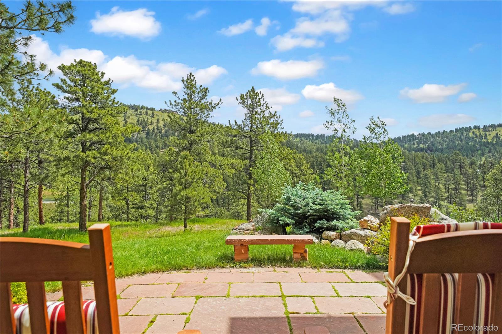 2398 Bitterroot Lane Golden, CO 80401 - Photo 3 of 34 a view of a garden with plants and a lake view