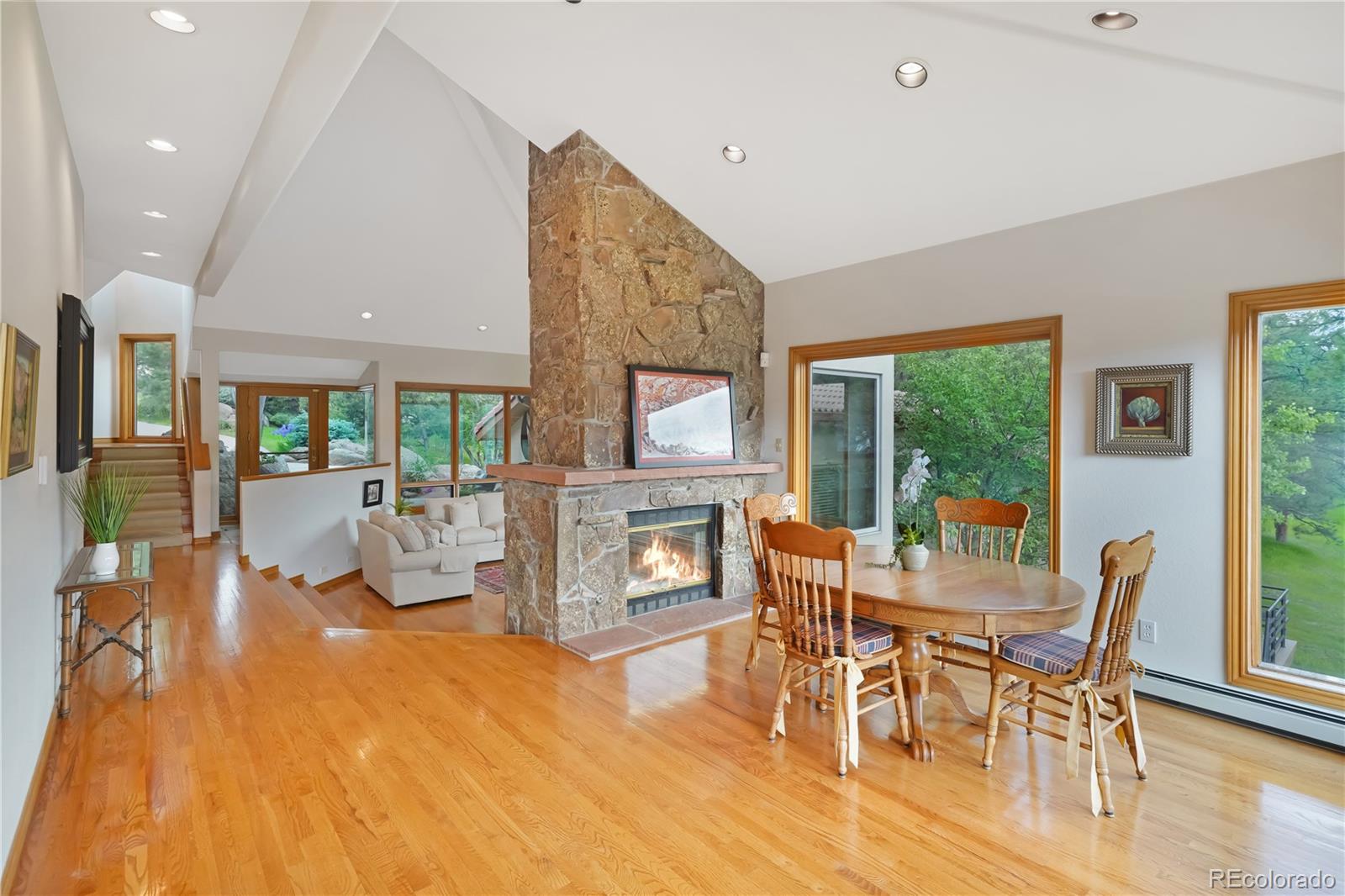 2398 Bitterroot Lane Golden, CO 80401 - Photo 8 of 34 a dining room with furniture a fireplace and wooden floor