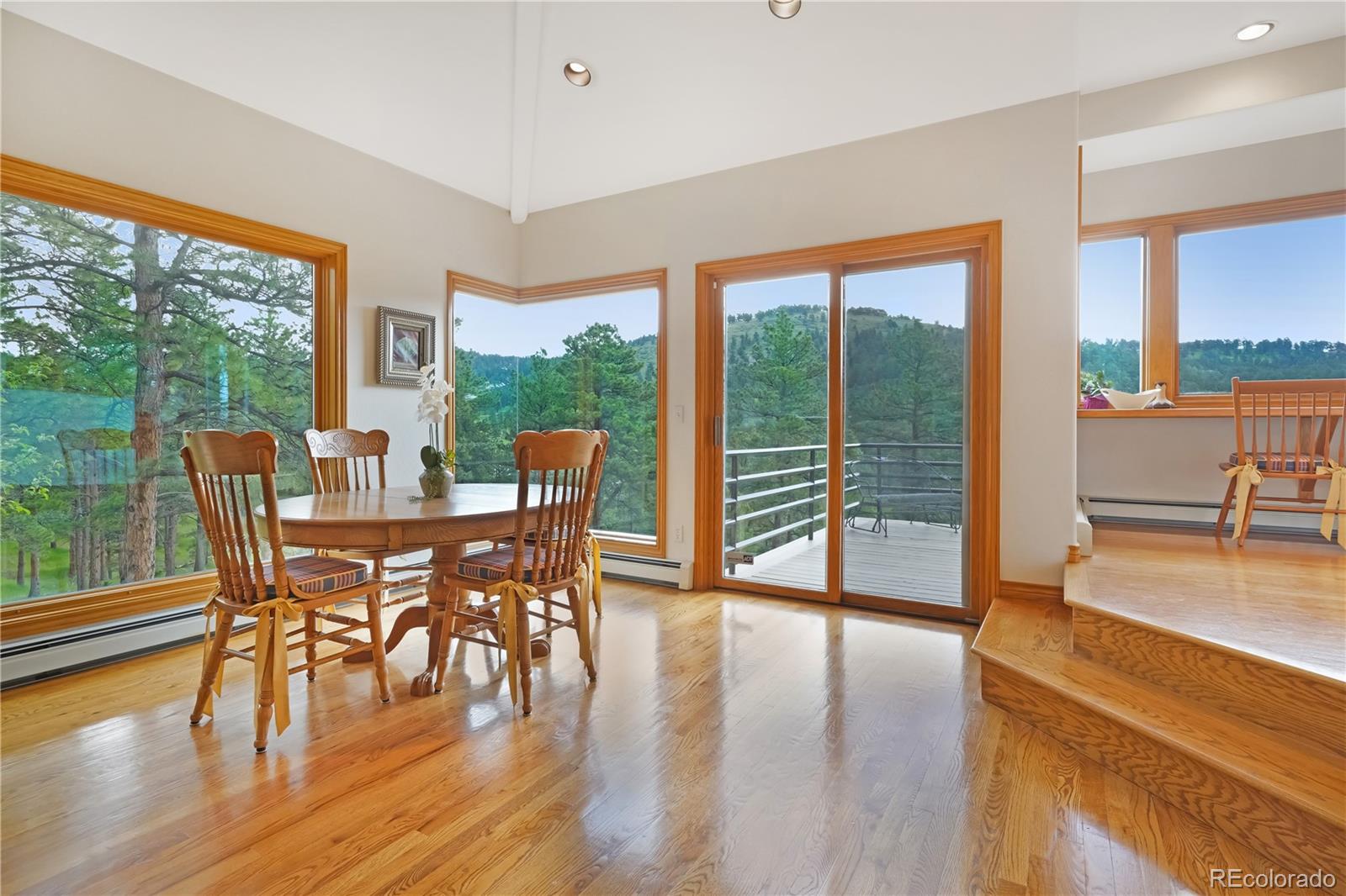 2398 Bitterroot Lane Golden, CO 80401 - Photo 9 of 34 a view of a dining room with furniture and wooden floor