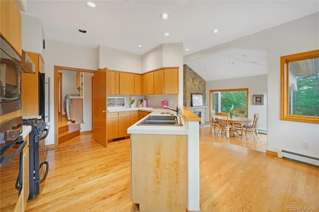 a view of a living room kitchen with a large window