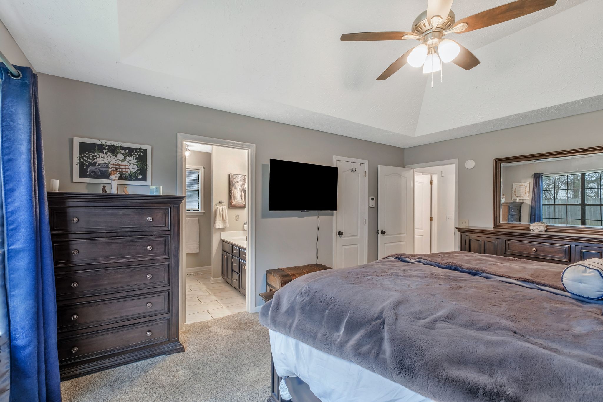 2048 Ransom Place Nashville, TN 37217 - Photo 19 of 30 a bedroom with a bed a mirror and a flat tv screen on dresser