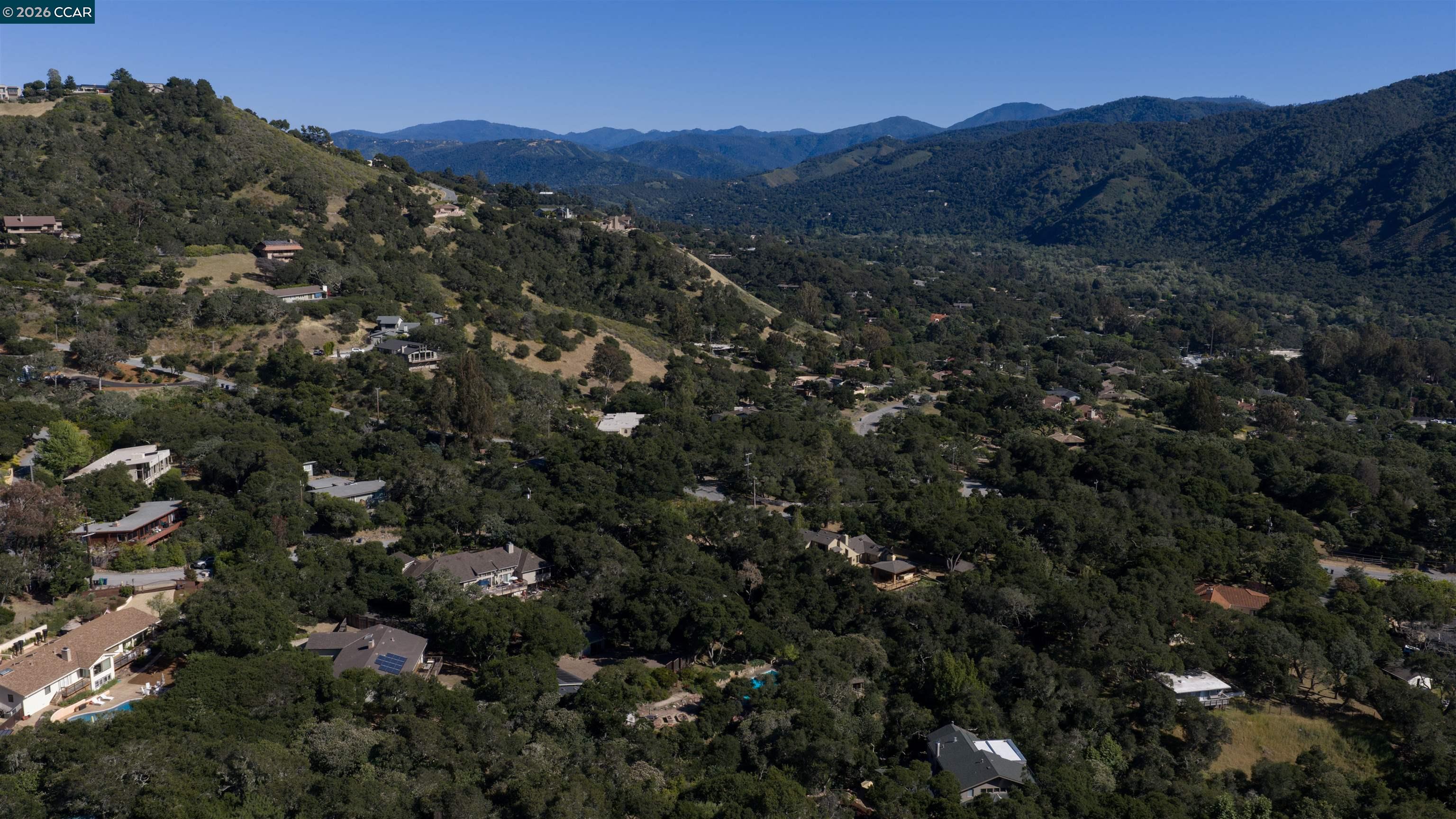 12 Marquard Road Carmel Valley, CA 93924 - Photo 34 of 36 a view of a houses with a lush green hillside