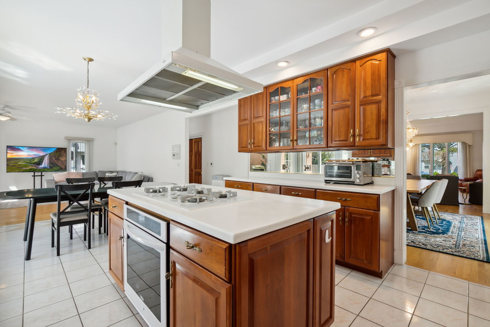 912 Elmdale Road Glenview, IL 60025 - Photo 19 of 55 a kitchen with a stove a sink a kitchen island with chairs and wooden cabinets