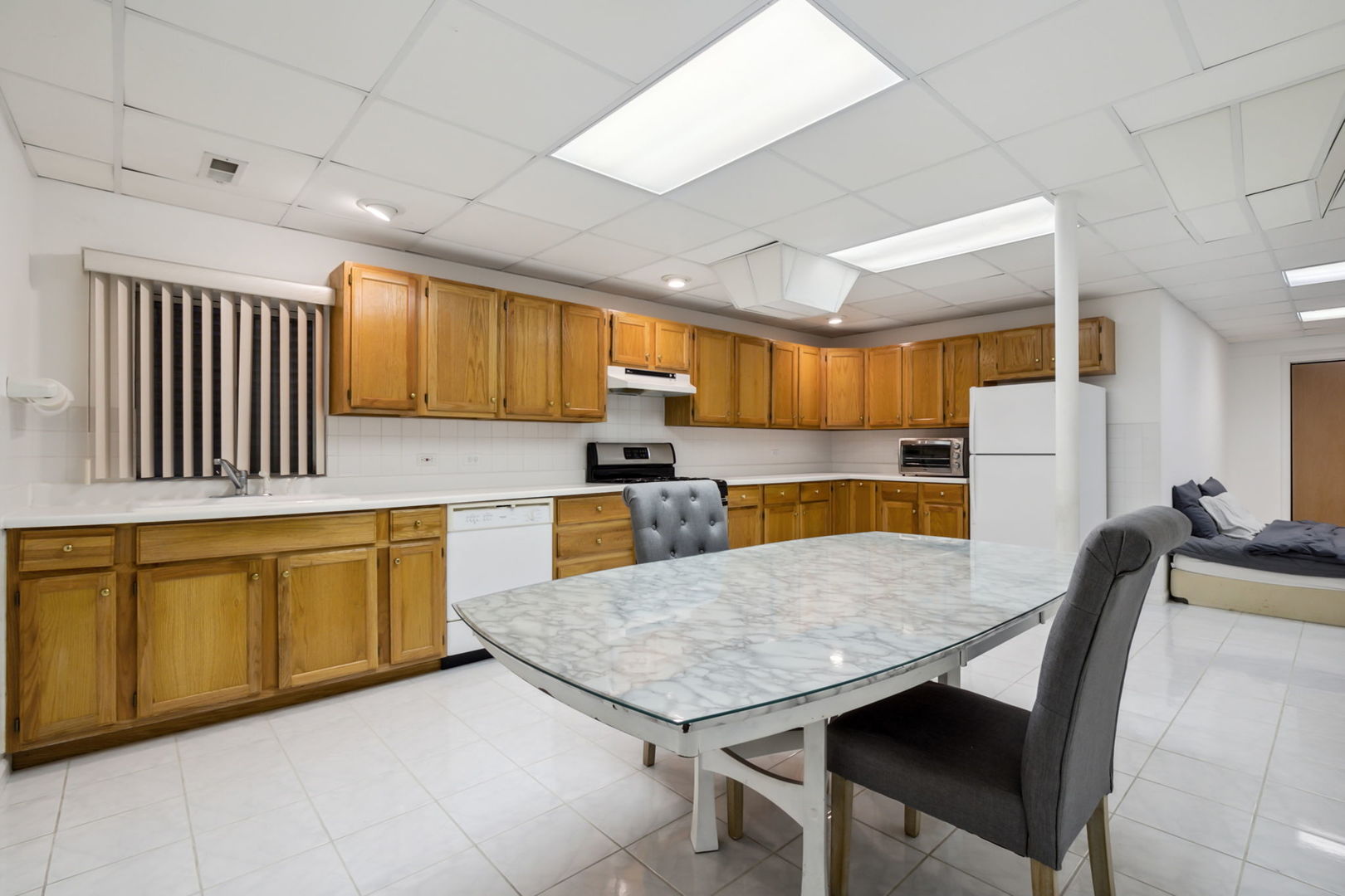 912 Elmdale Road Glenview, IL 60025 - Photo 42 of 55 a kitchen with stainless steel appliances granite countertop table chairs sink and cabinets