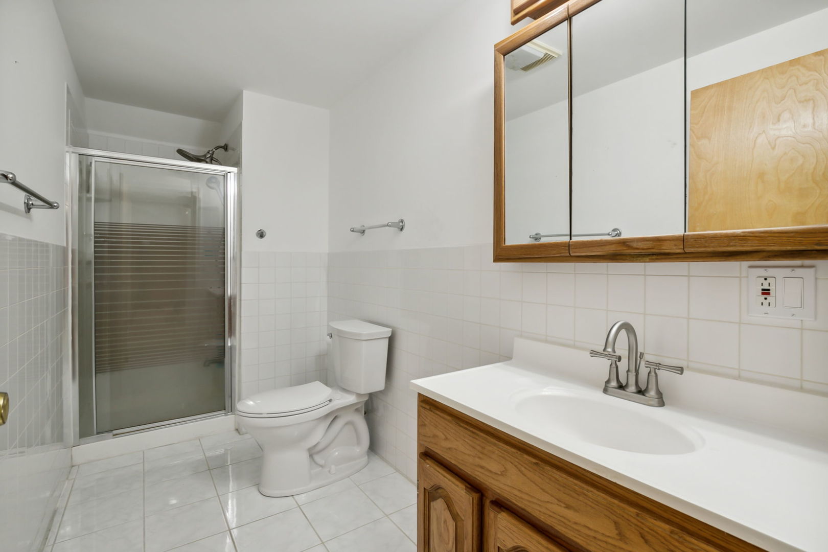 912 Elmdale Road Glenview, IL 60025 - Photo 47 of 55 a bathroom with a sink a toilet and shower