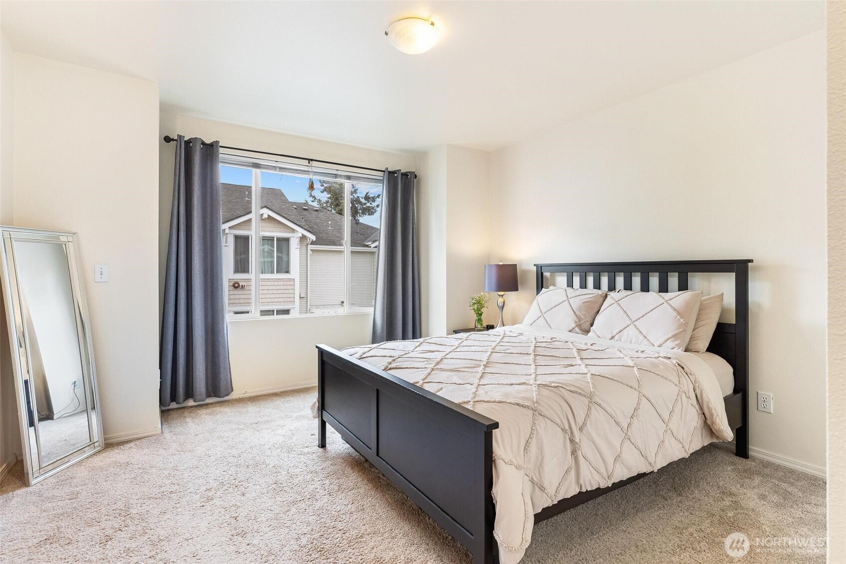 11856 Northeast 162nd Lane, Unit 94 Bothell, WA 98011 - Photo 12 of 36 a large bed sitting in a bedroom next to a window