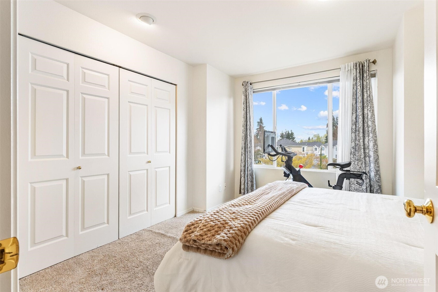 11856 Northeast 162nd Lane, Unit 94 Bothell, WA 98011 - Photo 16 of 36 a large bedroom with a bed and large windows