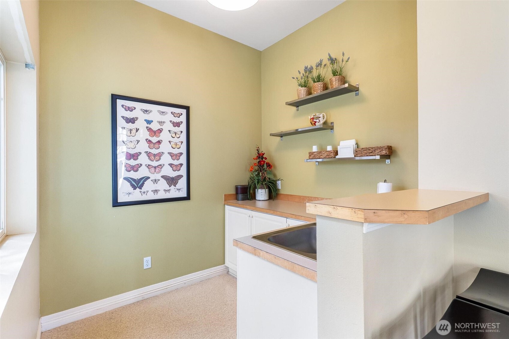 11856 Northeast 162nd Lane, Unit 94 Bothell, WA 98011 - Photo 29 of 36 a view of kitchen island with cabinets and wooden floor