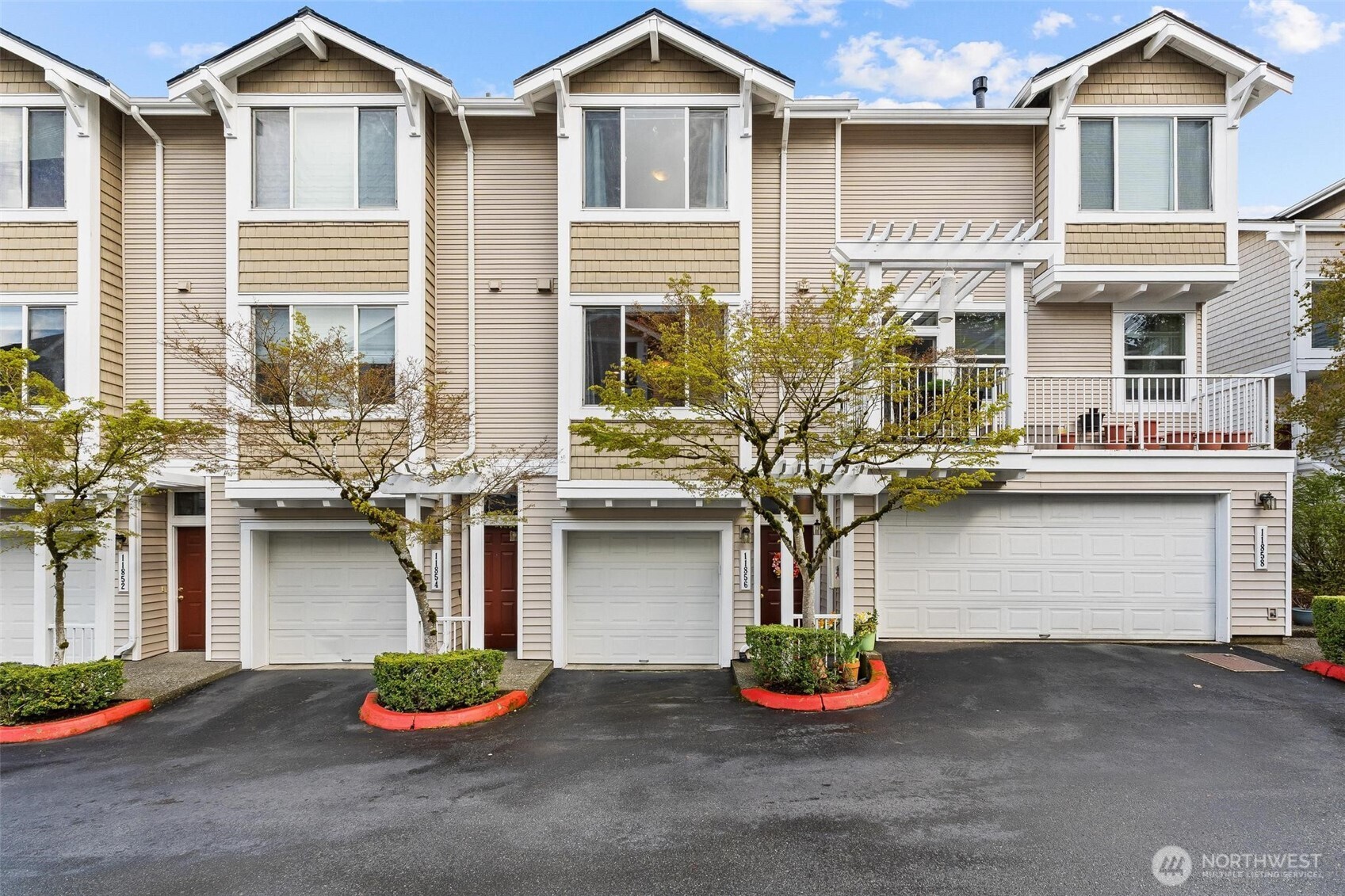 11856 Northeast 162nd Lane, Unit 94 Bothell, WA 98011 - Photo 36 of 36 a front view of a house with a yard and garage