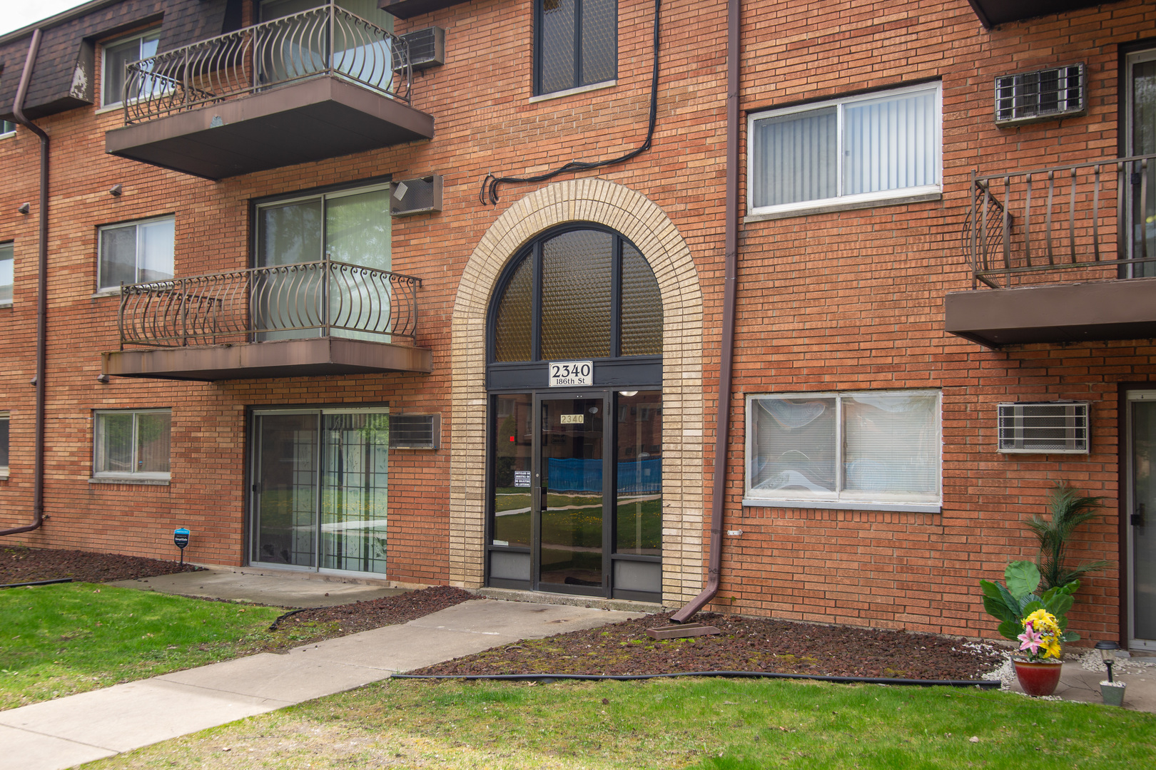 2340 186th Street, Unit 7 Lansing, IL 60438 - Photo 2 of 10 a front view of a house with garden