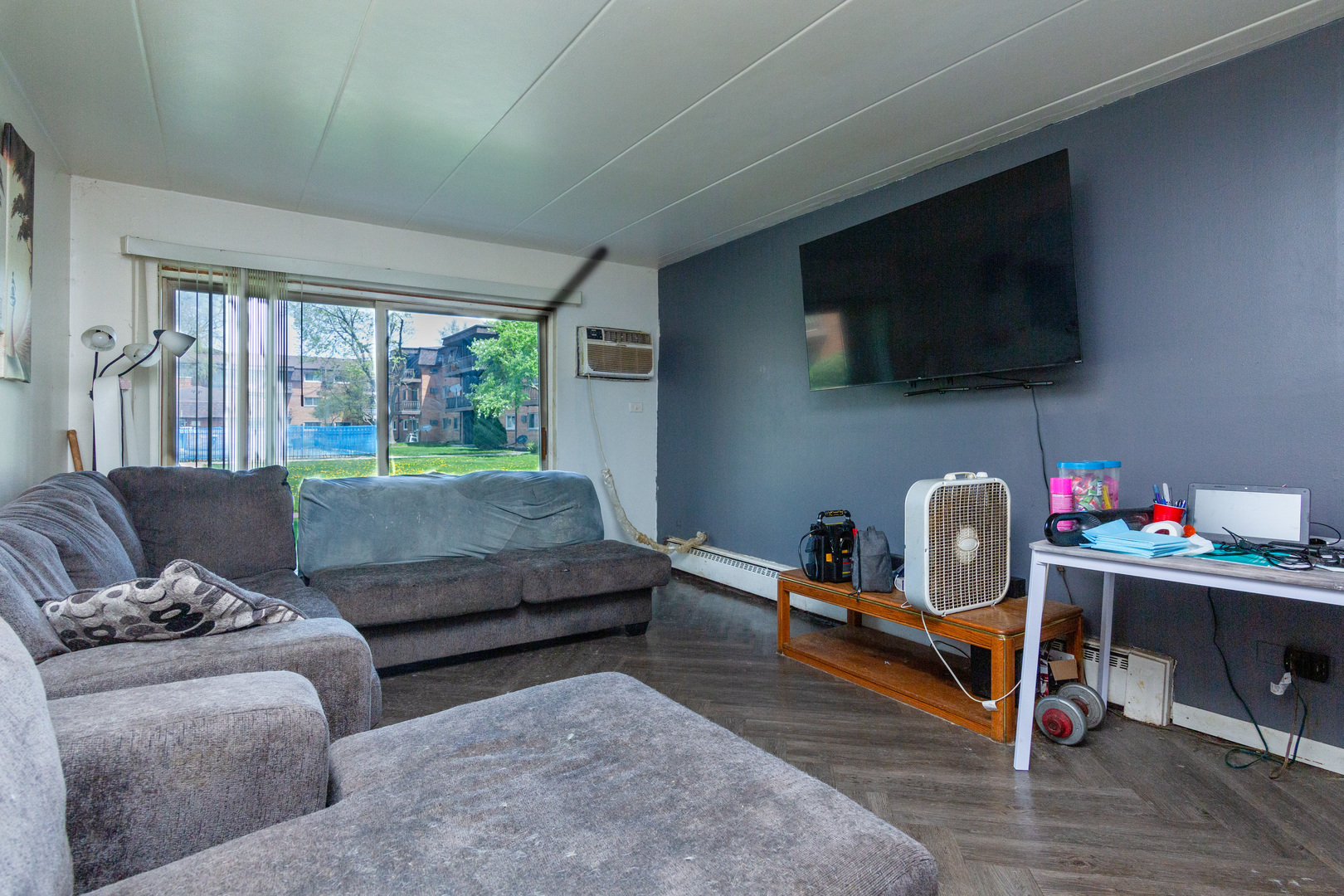 2340 186th Street, Unit 7 Lansing, IL 60438 - Photo 3 of 10 a living room with furniture and a flat screen tv