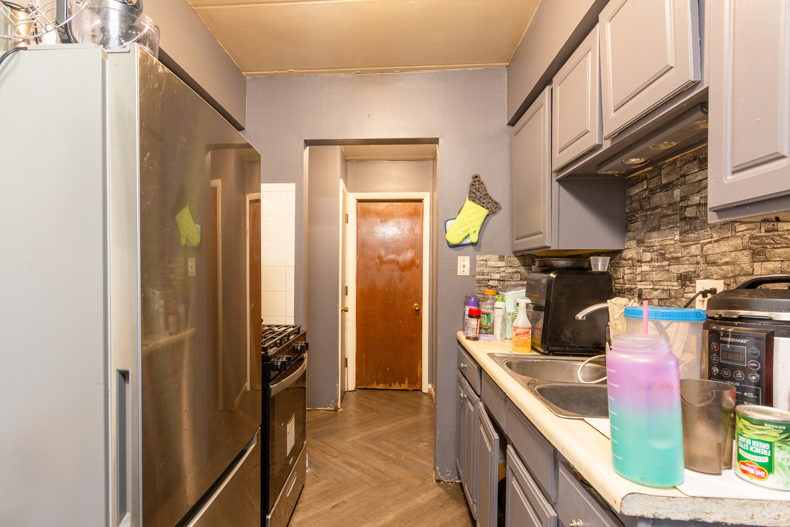 2340 186th Street, Unit 7 Lansing, IL 60438 - Photo 6 of 10 a kitchen with stainless steel appliances granite countertop a sink and a refrigerator