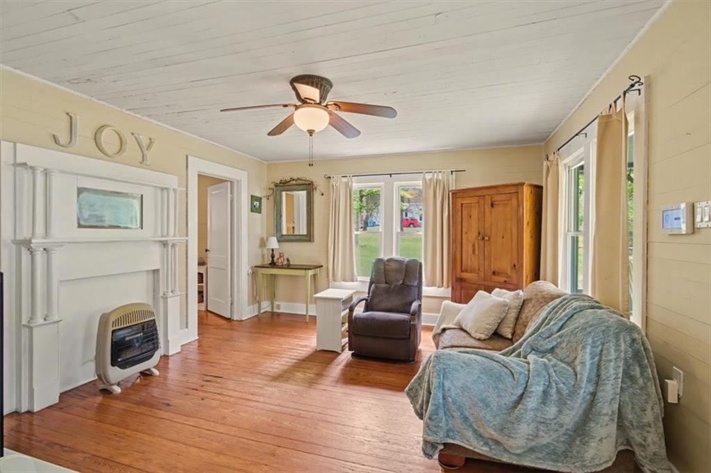 115 Price Street Bremen, GA 30110 - Photo 2 of 11 a living room with furniture a fireplace and a table