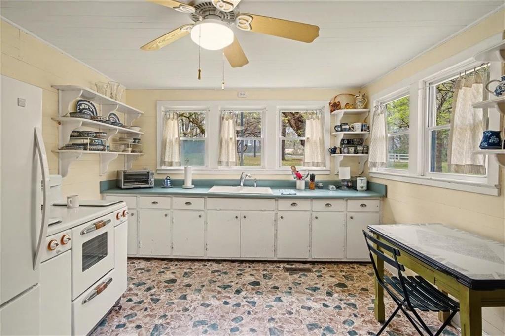 115 Price Street Bremen, GA 30110 - Photo 3 of 11 a kitchen with stainless steel appliances a stove a sink and a refrigerator