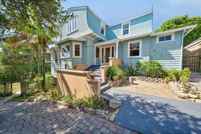 a view of a house with backyard sitting area and garden