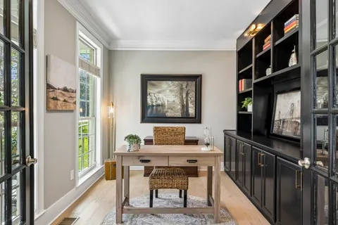 a view of a dining room with furniture and a chandelier