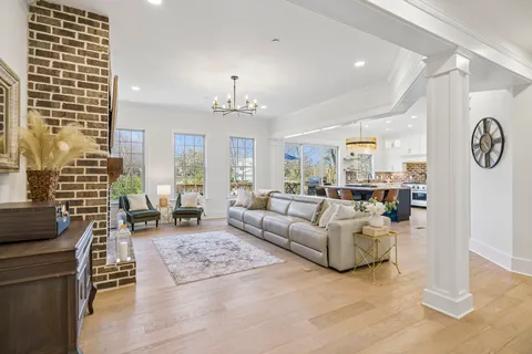a living room with granite countertop furniture and a flat screen tv