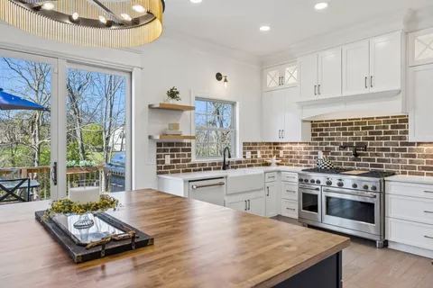 a kitchen with a sink stove and cabinets