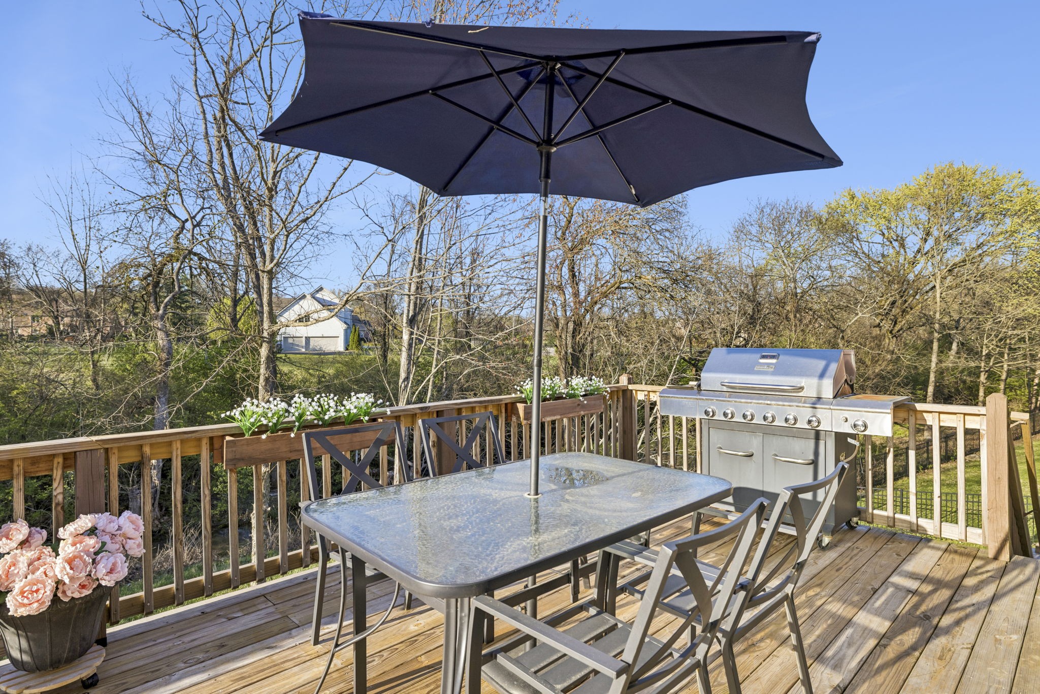 119 Stream Valley Boulevard Franklin, TN 37064 - Photo 77 of 100 a roof deck with table and chairs under an umbrella