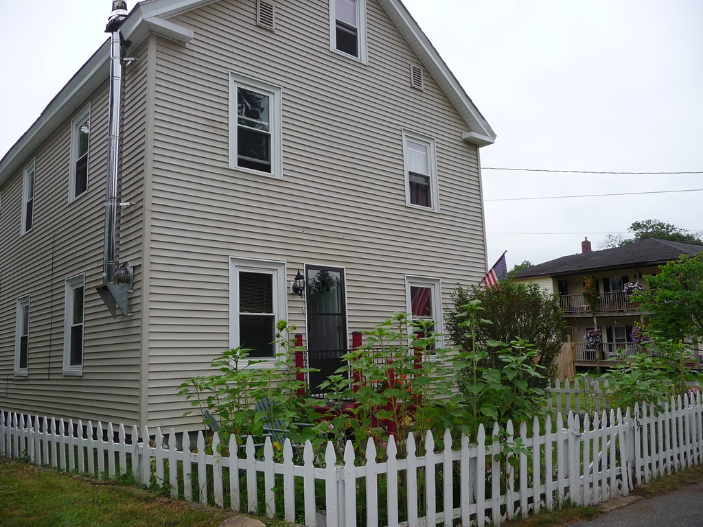 a front view of a house with a garden