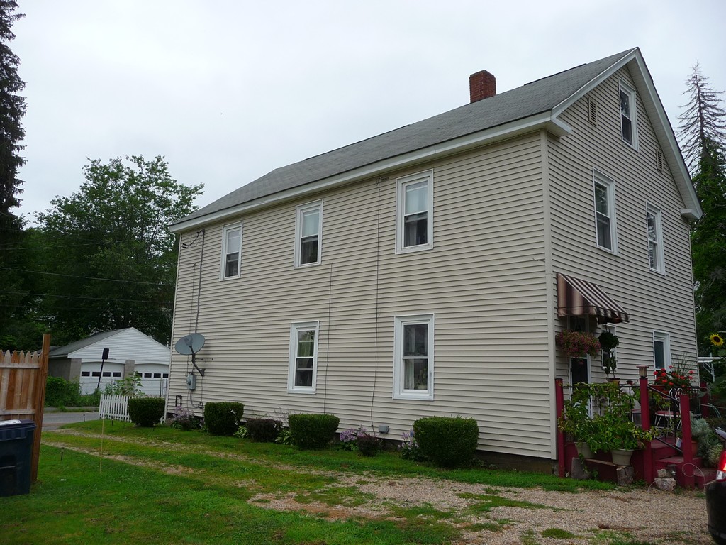 19 Chapel Street Warren, MA 01092 - Photo 23 of 30 a view of a white house with a yard and plants