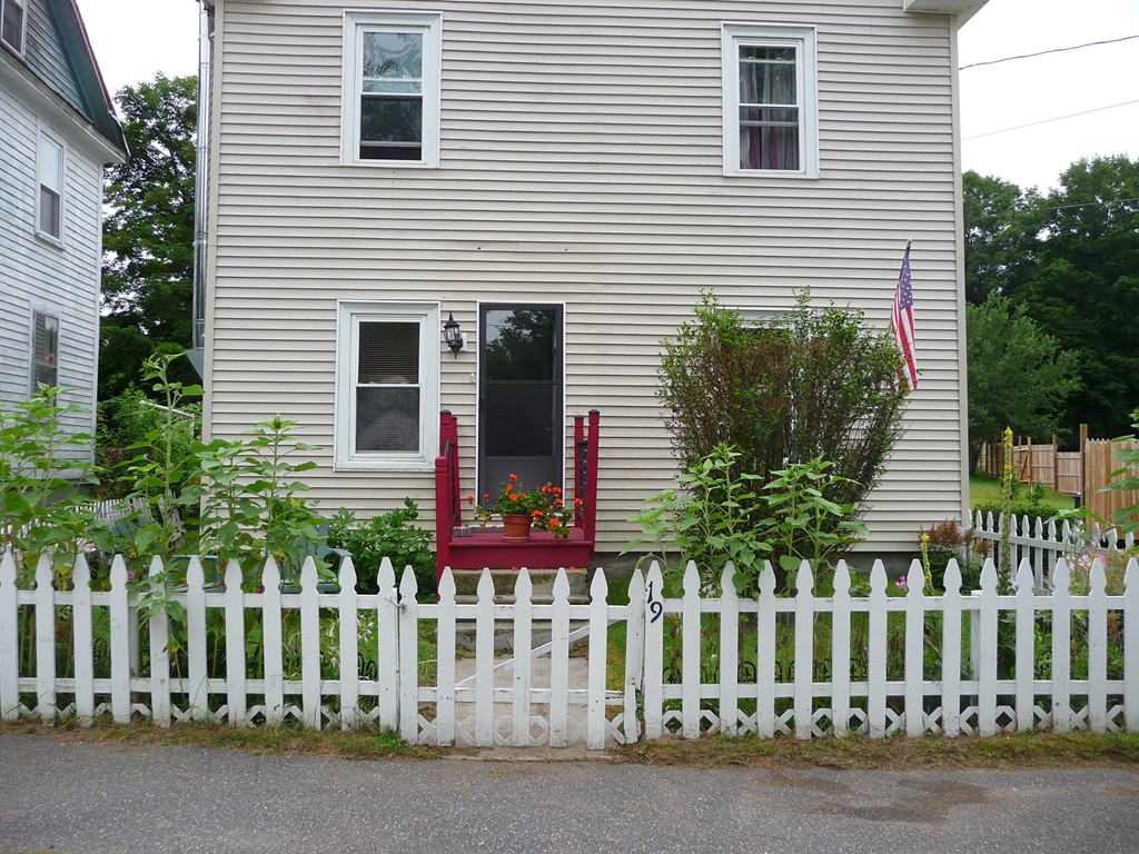 19 Chapel Street Warren, MA 01092 - Photo 27 of 30 a view of a house with a small yard and wooden fence