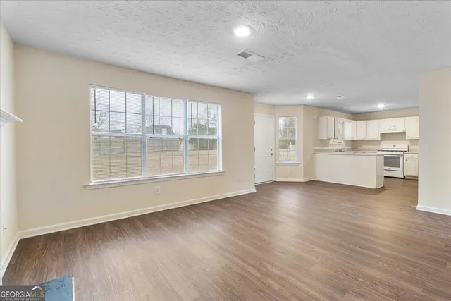 a view of a kitchen with a sink and a refrigerator