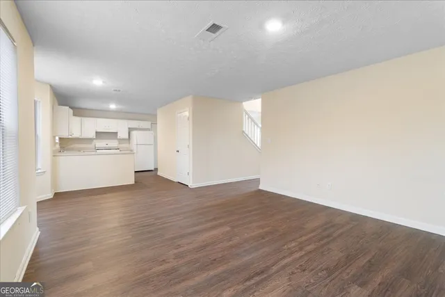 a view of a kitchen with wooden floor