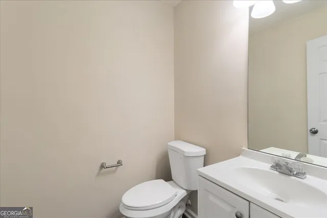 an empty room with windows and chandelier fan