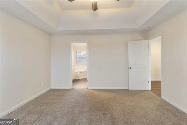a bathroom with a tub a sink and mirror