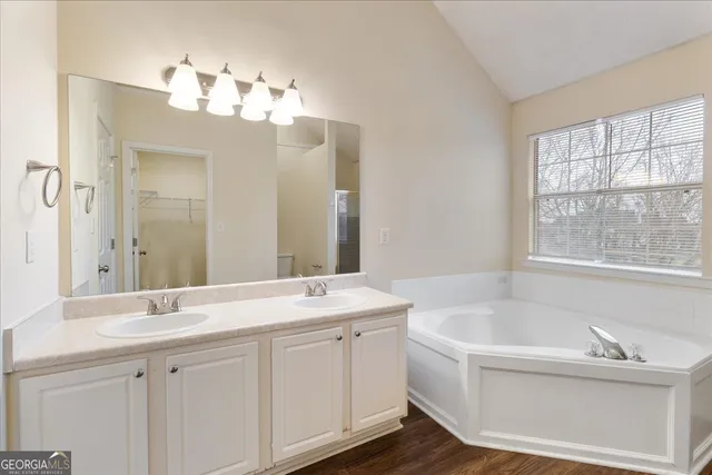 a white bath tub sitting in a bathroom next to a window