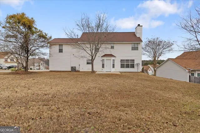 a view of a house with a yard covered in snow