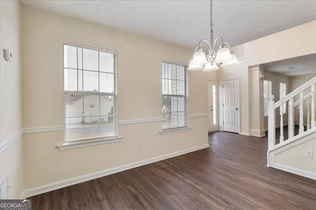 a view of a livingroom with wooden floor and windows