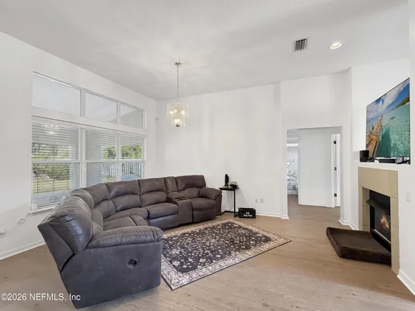 a living room with furniture a flat screen tv and a fireplace