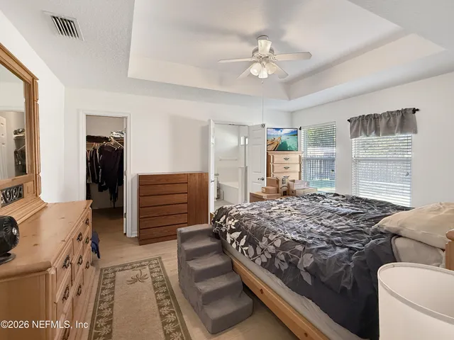 a bedroom with a bed and a television