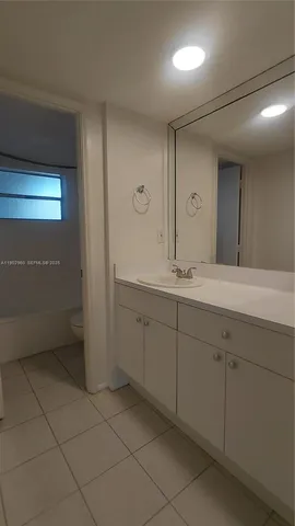 a white toilet sitting next to a bath tub