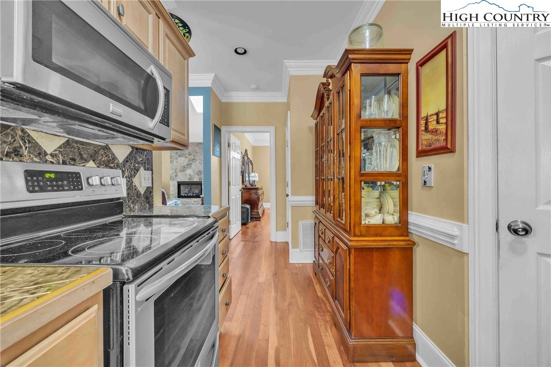 127 Deerfield Road West Jefferson, NC 28694 - Photo 18 of 47 a kitchen with granite countertop a sink and a stove top oven
