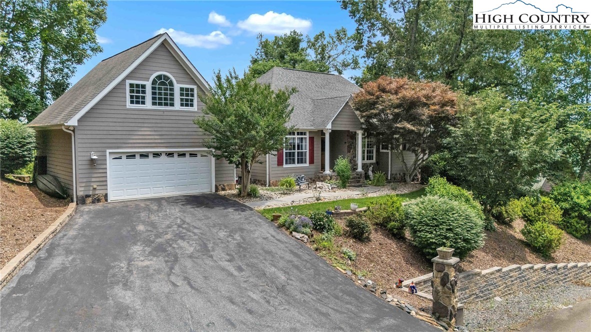 127 Deerfield Road West Jefferson, NC 28694 - Photo 2 of 47 a front view of a house with a yard and garage