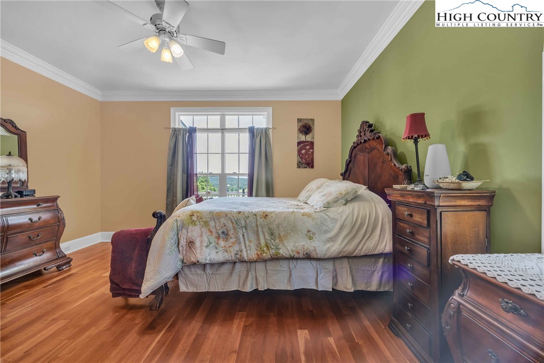 127 Deerfield Road West Jefferson, NC 28694 - Photo 22 of 47 a bed sitting in a bedroom next to a window